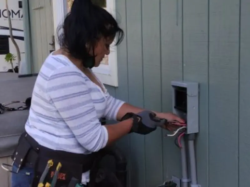 Licensed electrician wiring an exterior subpanel in Chittenango